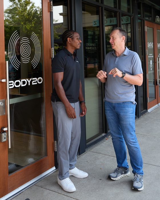 Neil Tunmore in conversation with a business owner outside the Body20 studio in Lake Oswego